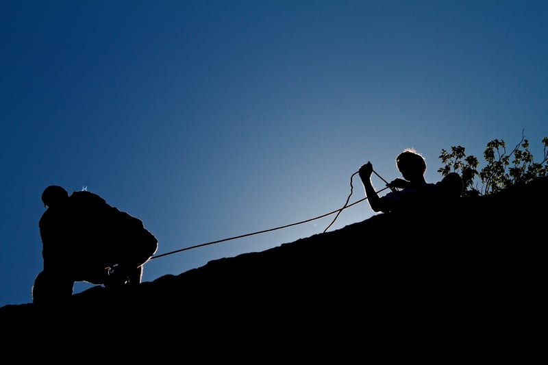Belaying a climber at Hueco Tanks.