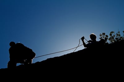 Belaying a climber at Hueco Tanks.